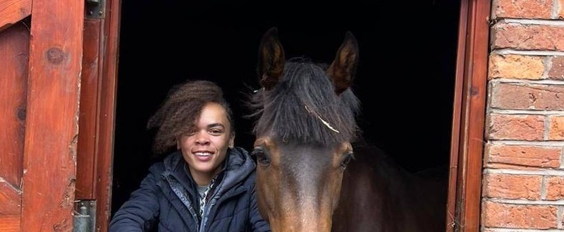 Lydia at the stable door with a horse